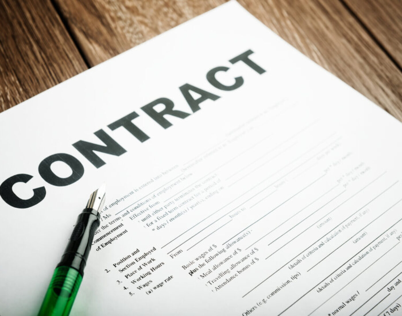 A contract with a pen on top of it.