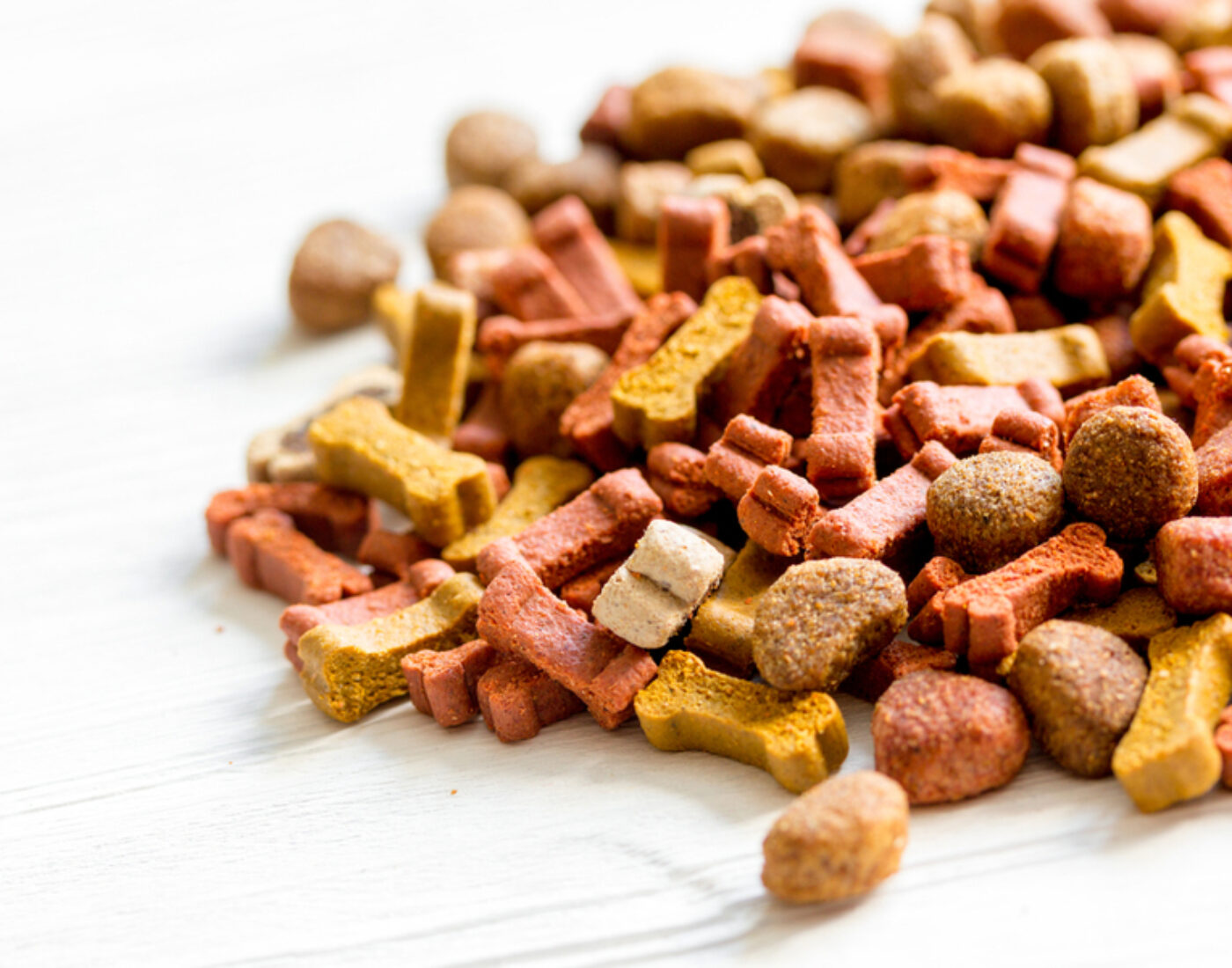 A pile of dog food on a white table.